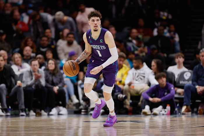 Charlotte Hornets guard LaMelo Ball dribbles the ball up the court.